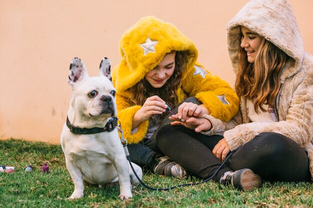 Girls with dog on grass