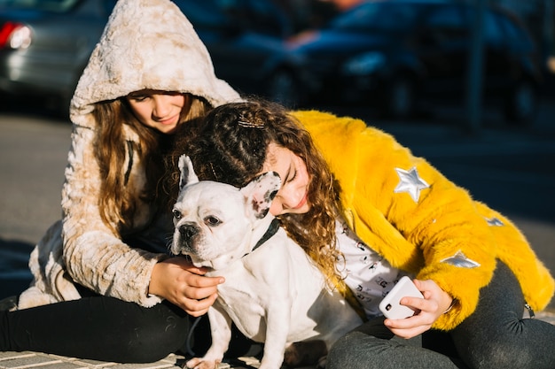 Girls with dog on street