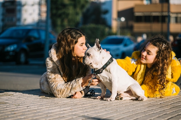 Girls with dog on street