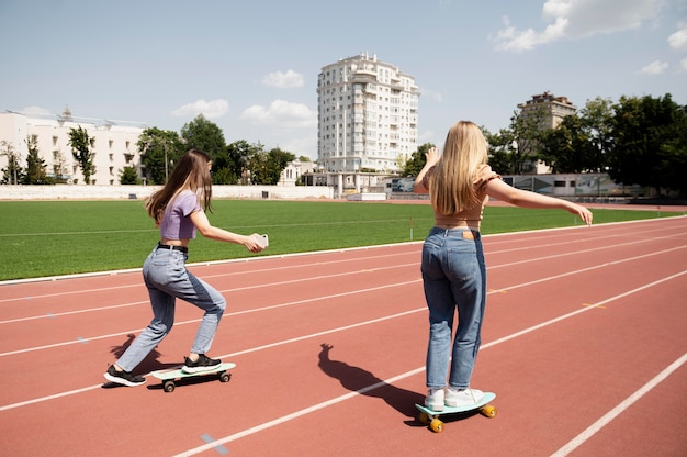 Girls with penny boards full shot
