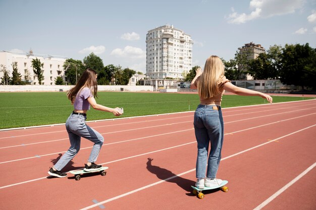 Girls with penny boards full shot