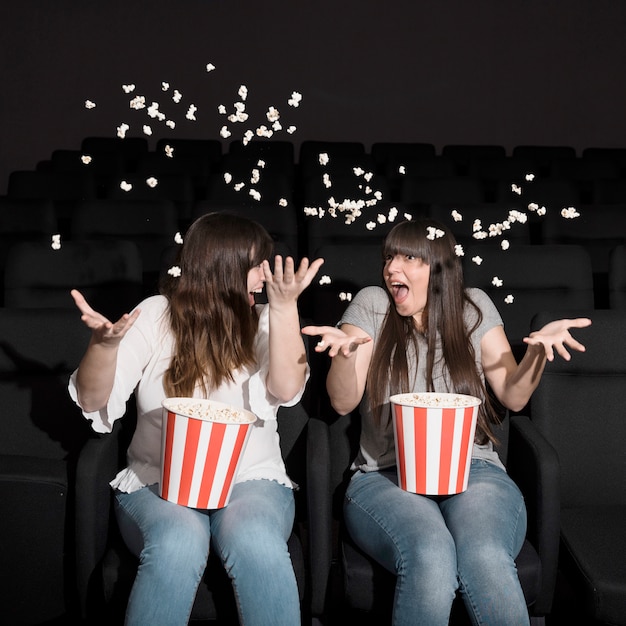 Girls with popcorn in cinema