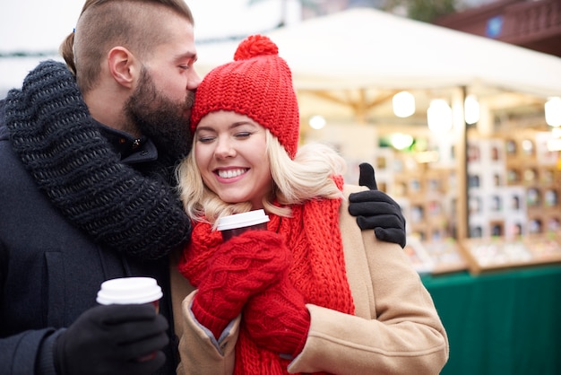 Giving a kiss and drining hot coffee
