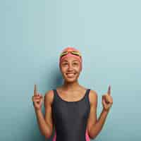 Free photo glad attractive female swimmer posing with goggles