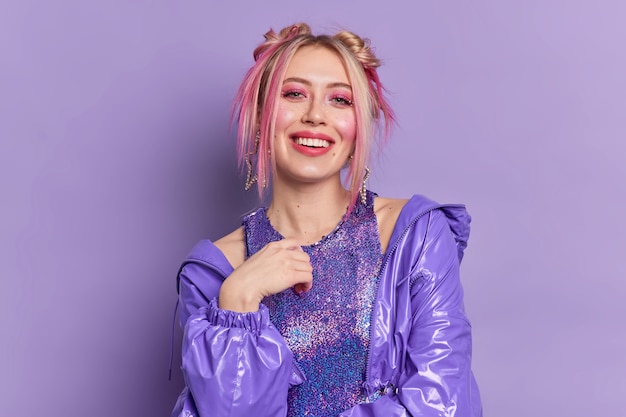 Glad blonde beautiful european woman with bright vivid makeup dressed in fashionable clothes poses