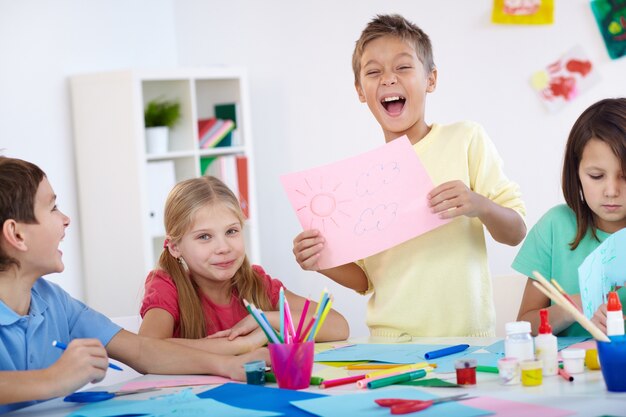 Glad boy showing his artwork