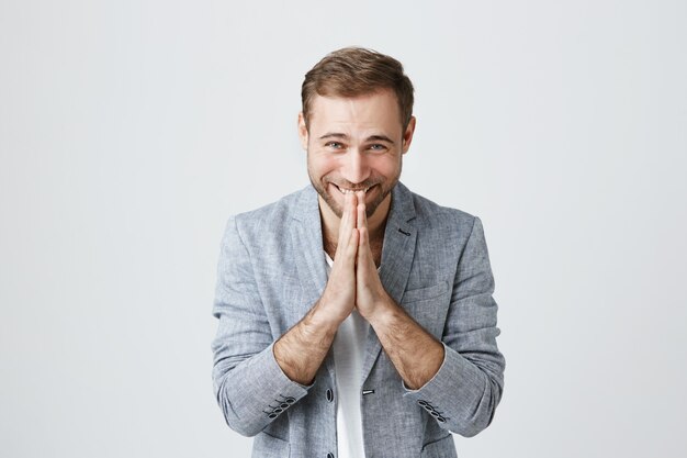 Glad happy man thanking, bow with hands in plead