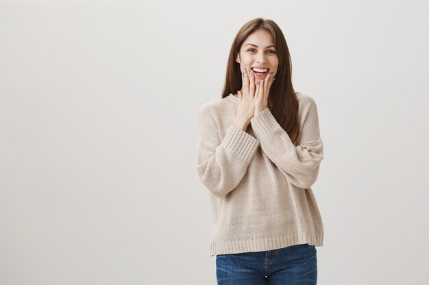 Glad happy woman react to amazing news or surprise, looking flattered