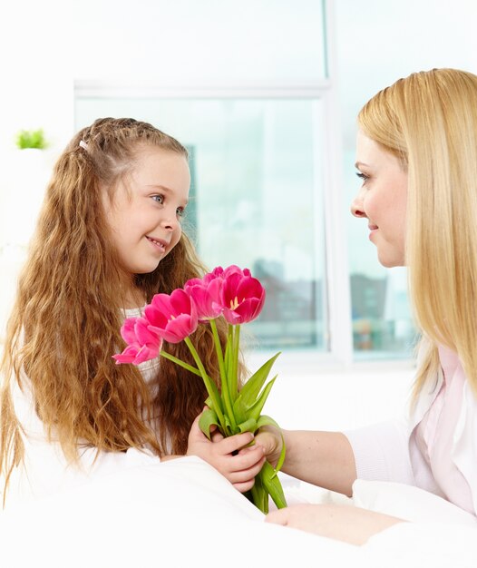 Glad little girl with flowers