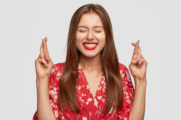 Free photo glad woman with red lipstick posing against the white wall