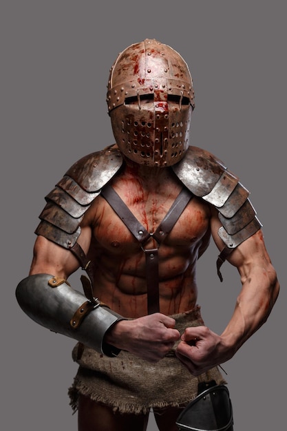 Free photo gladiator with muscular body shows his strength