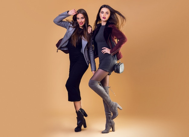 Glamorous pretty women posing and wearing casual winter jackets