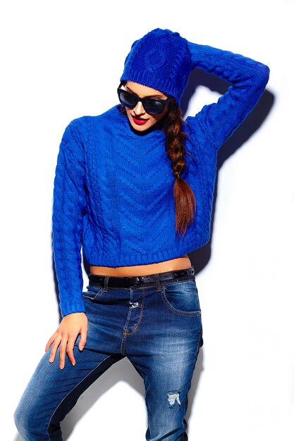 glamour stylish beautiful  young woman model with red lips  in blue sweater hipster cloth in beanie