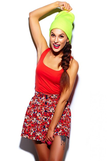 glamour stylish beautiful  young woman model with red lips  in summer bright colorful  hipster cloth in yellow beanie