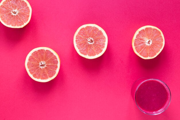 Glas with smoothie of grapefruit on table