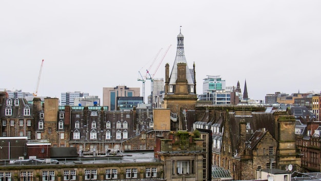 Glasgow cityscape United Kingdom Roofs of multiple old residential and modern buildings cloudy