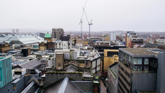 Glasgow cityscape United Kingdom Roofs of multiple old residential and modern buildings cloudy