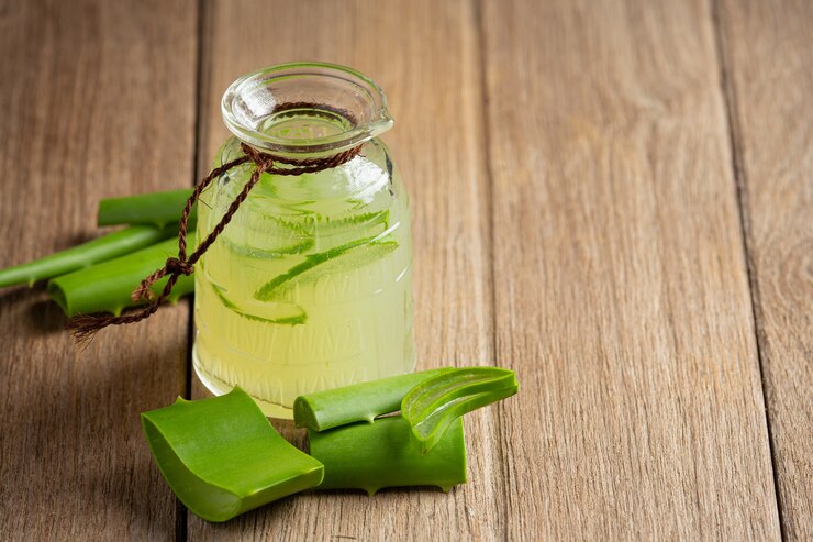 glass of aloe vera  juice put on wooden  floor