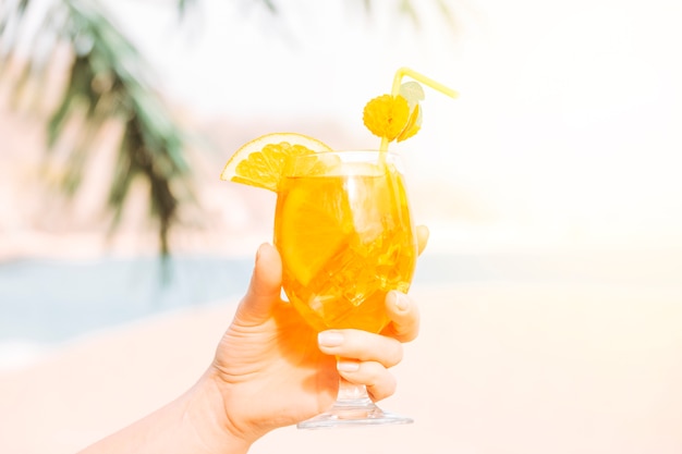 Glass of aromatic orange drink  in hand