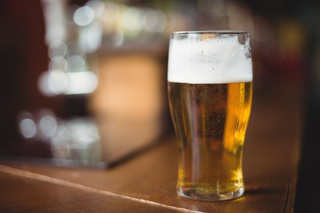 Glass of beer in bar counter