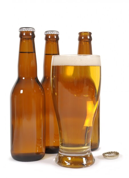 Glass of beer with brown bottles