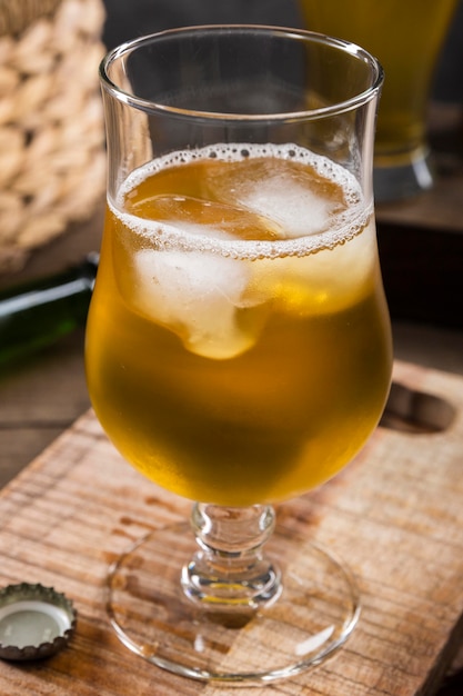 Glass of beer with ice cubes