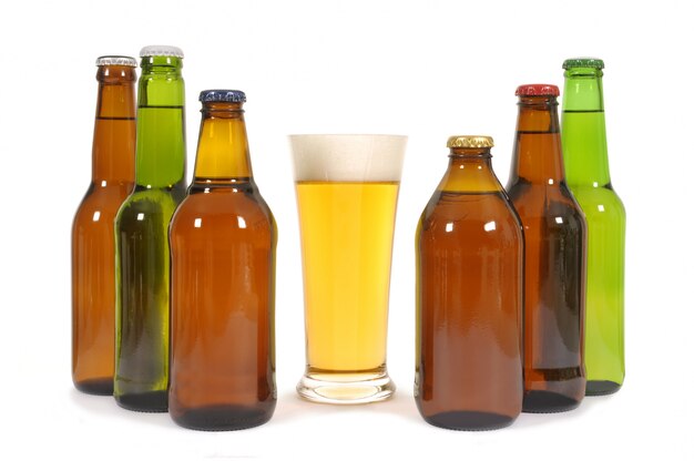 Glass of beer with various bottles