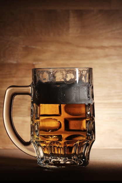 Glass of beer over wooden surface