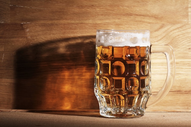Glass of beer over wooden surface