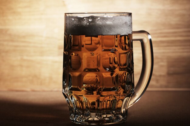 Glass of beer over wooden surface