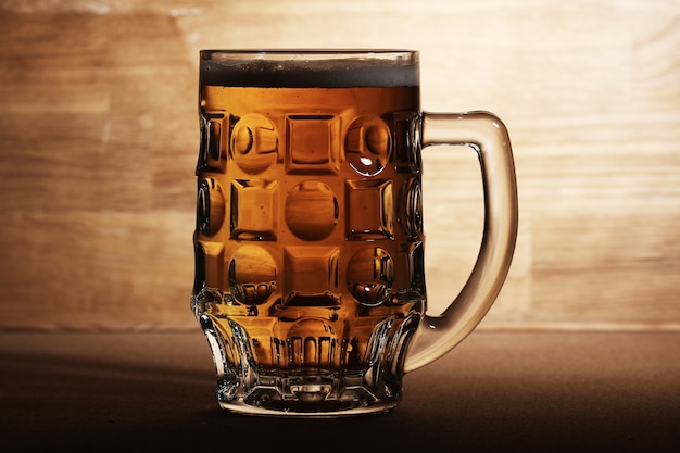 Glass of beer over wooden surface