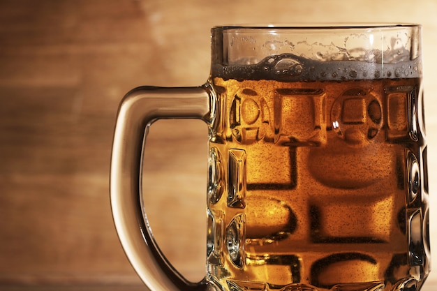 Glass of beer over wooden surface