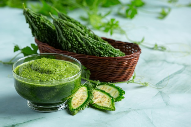 a glass of bitter gourd smoothie with shopped bitter gourd