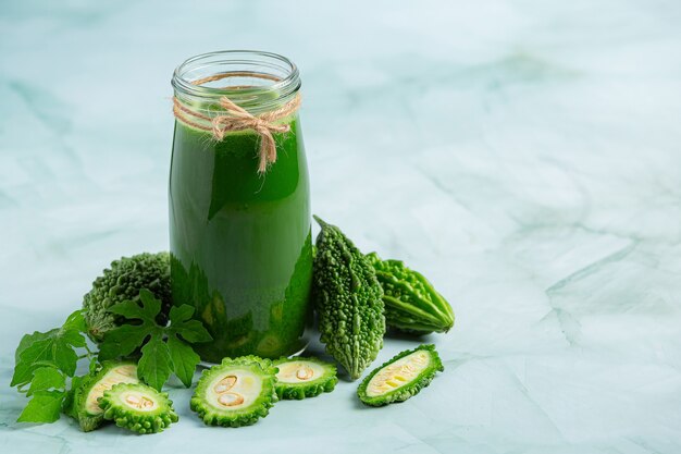 a glass of bitter gourd smoothie with shopped bitter gourd