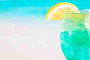 Free photo glass of bright blue drink with lime