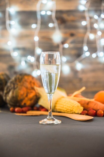Glass of champagne on table with vegetables