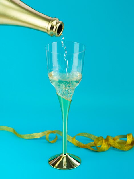 Glass of champagne with golden ribbon