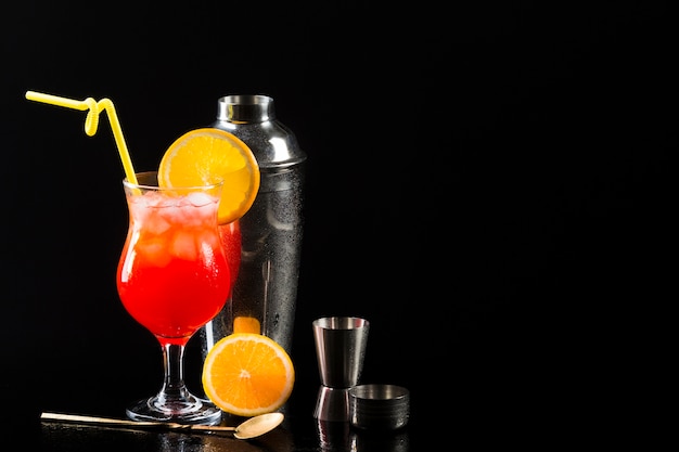 Foto gratuita bicchiere di cocktail con shaker e copia spazio