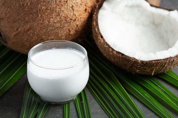 glass of coconut milk put on dark background