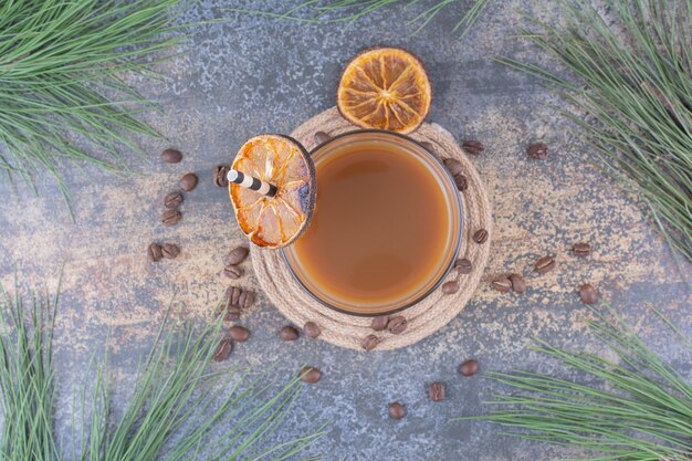 Glass of coffee with straw and orange slices. High quality photo