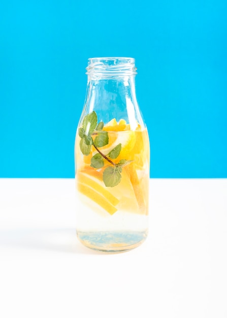 Glass container filled with slices of orange and water