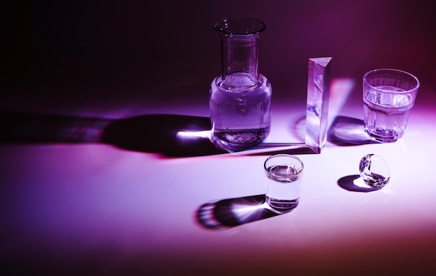 Glass container; prism and diamond with dark shadow on colored background