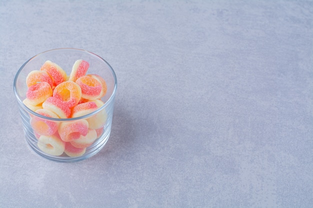 Free photo a glass cup full of colorful fruit sugary marmalades