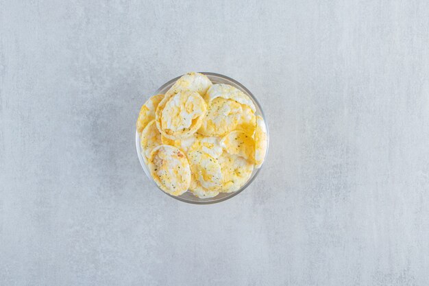 Glass of delicious crispy rice cakes on stone.