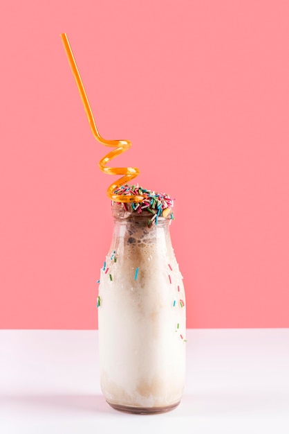 Glass of dessert with straw and candy