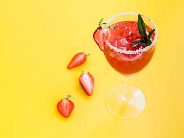 Glass of drink with strawberries and salt