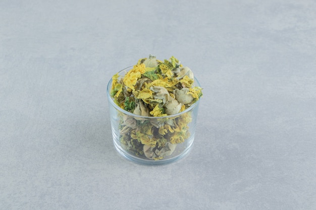 Glass of dry chrysanthemum flowers