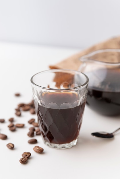 Glass filled with coffee and coffee beans