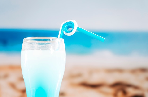 Glass of fresh blue drink with straw 