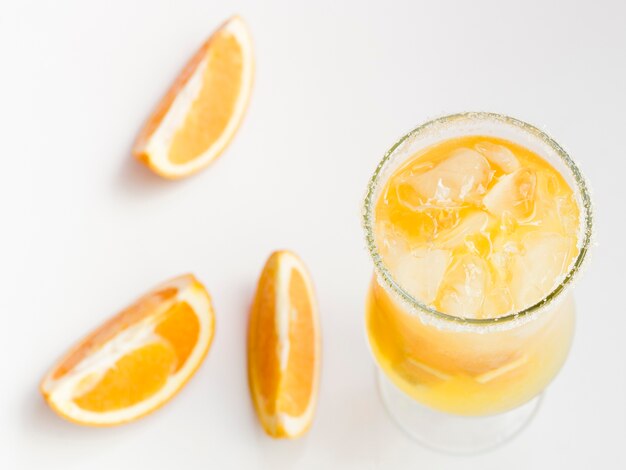Glass of fresh cold orange cocktail with ice